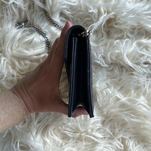 YSL WOC in midnight navy with chevron lines.